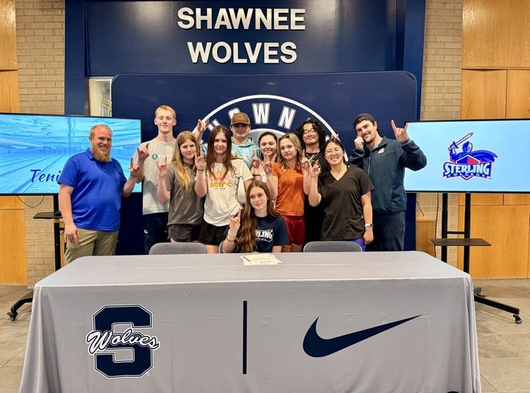 group of students posing at table