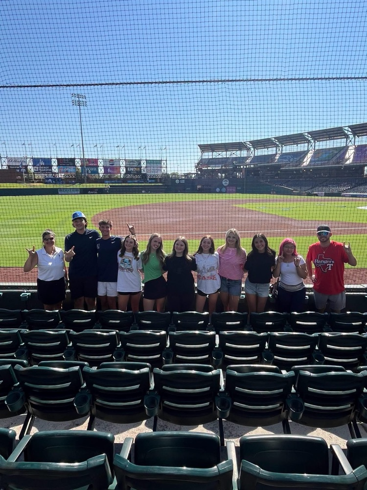students standing in baseball stands