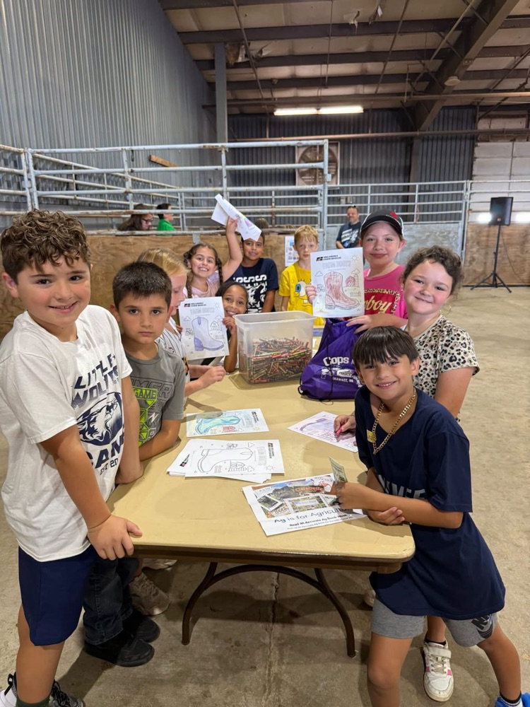 group of elementary students around table