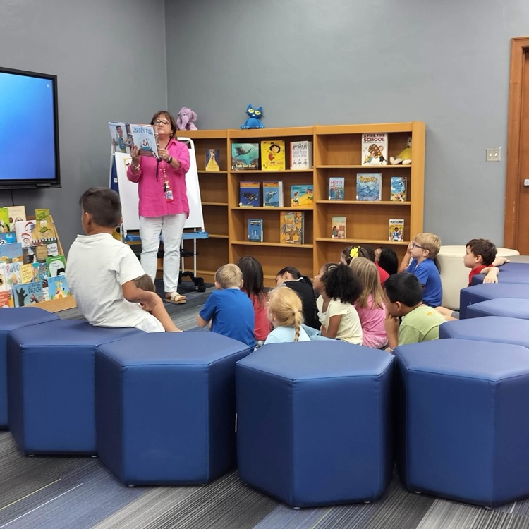 students being read to in library