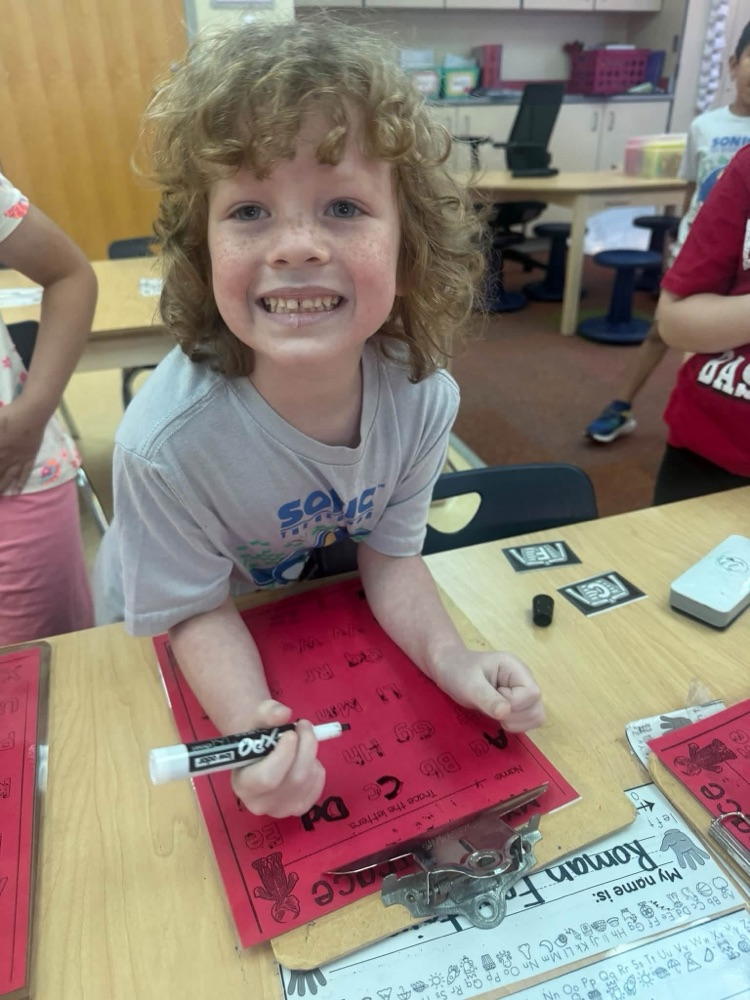 student smiling with work