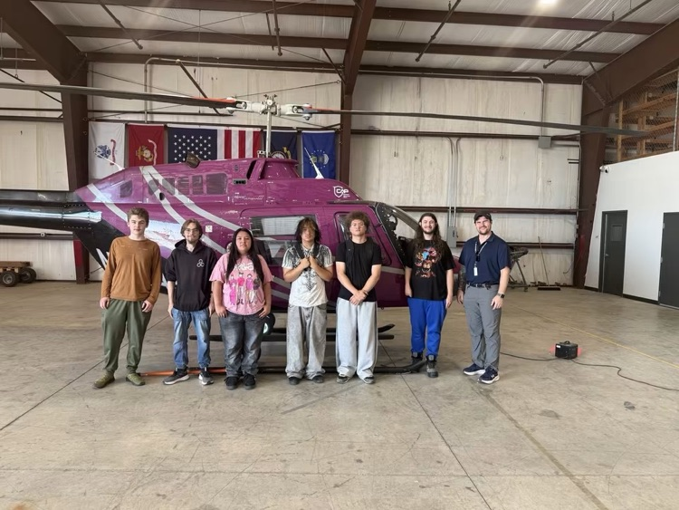 high school students with airplane 