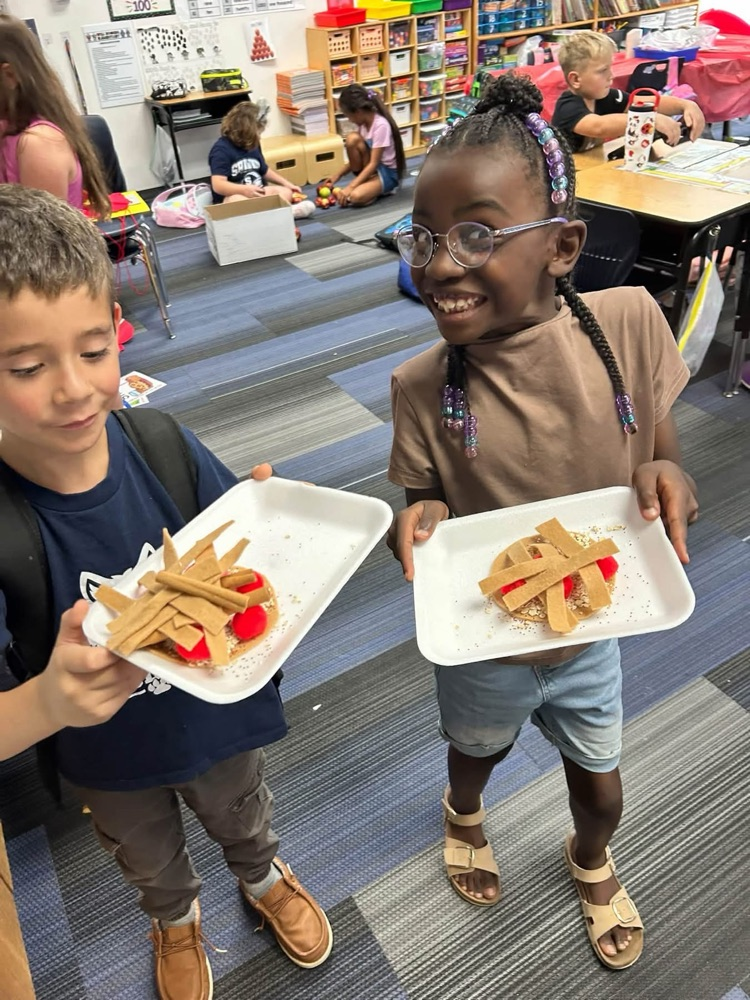 two children holding play apple pie