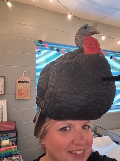 Women with turkey hat on head.