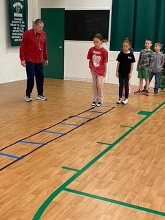 Students in a line waiting to do the agility ladder