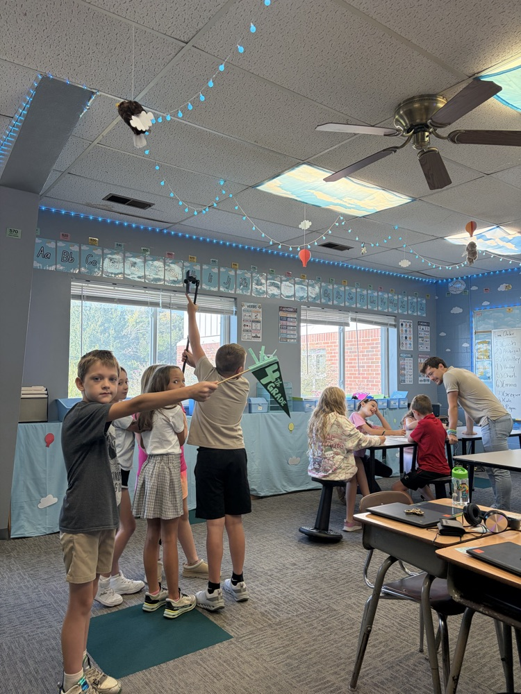3rd Graders holding up fake camera filming the 4th graders