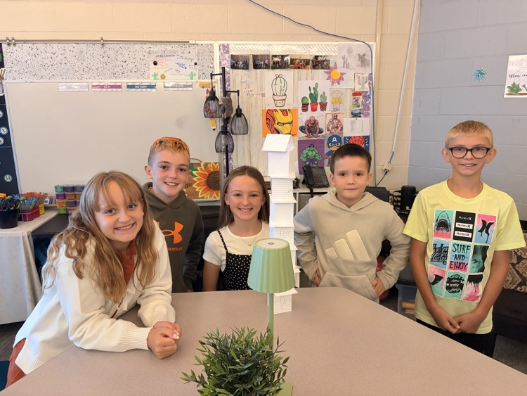 students building paper tower