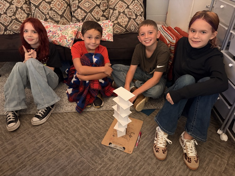students building paper tower