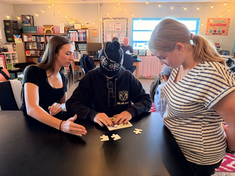student putting together a puzzle while blindfolded