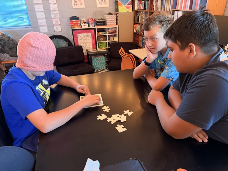 student putting together a puzzle while blindfolded