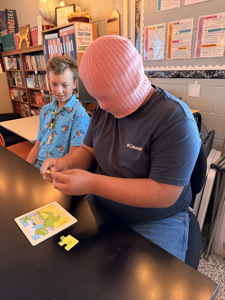 student putting together a puzzle while blindfolded