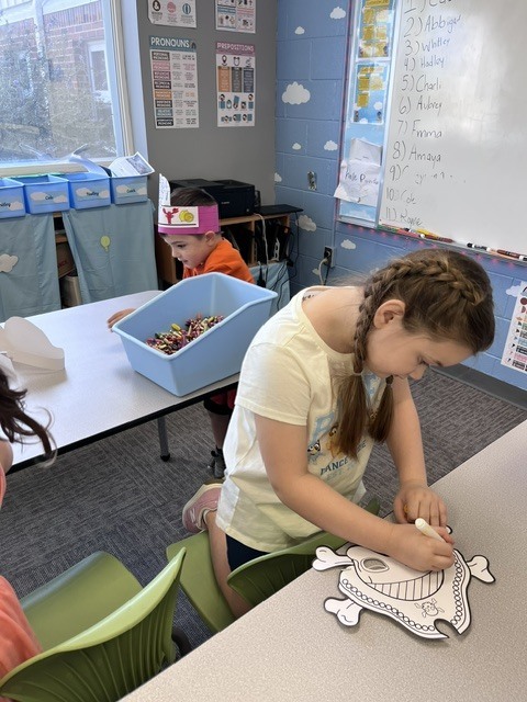 Student coloring a pirate mask.