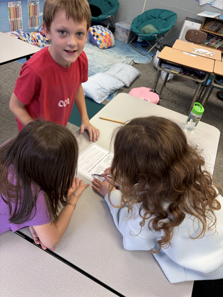 Students working together on community paper