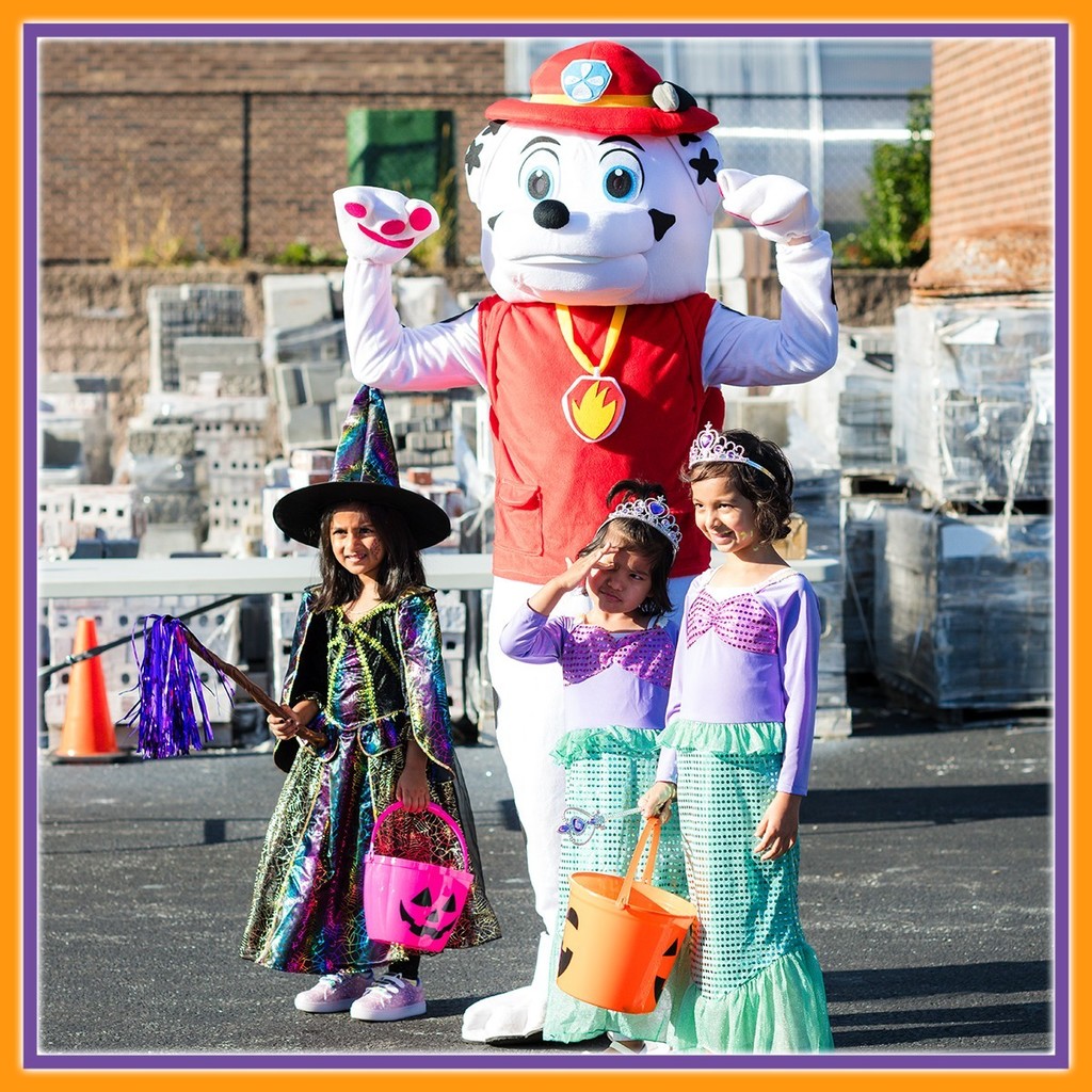 Two children dressed up as a mermaid, a girl as a little witch and posing with marshal from paw patrol
