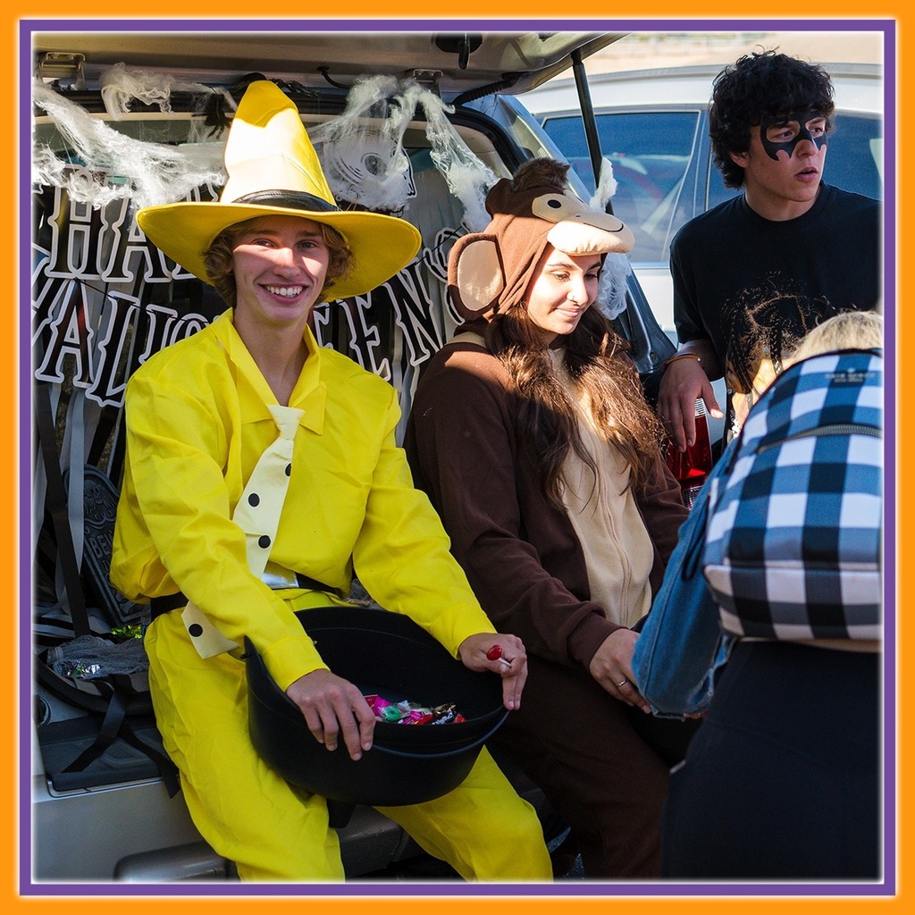 Some dressed up as curious George and the man in the yellow hat 