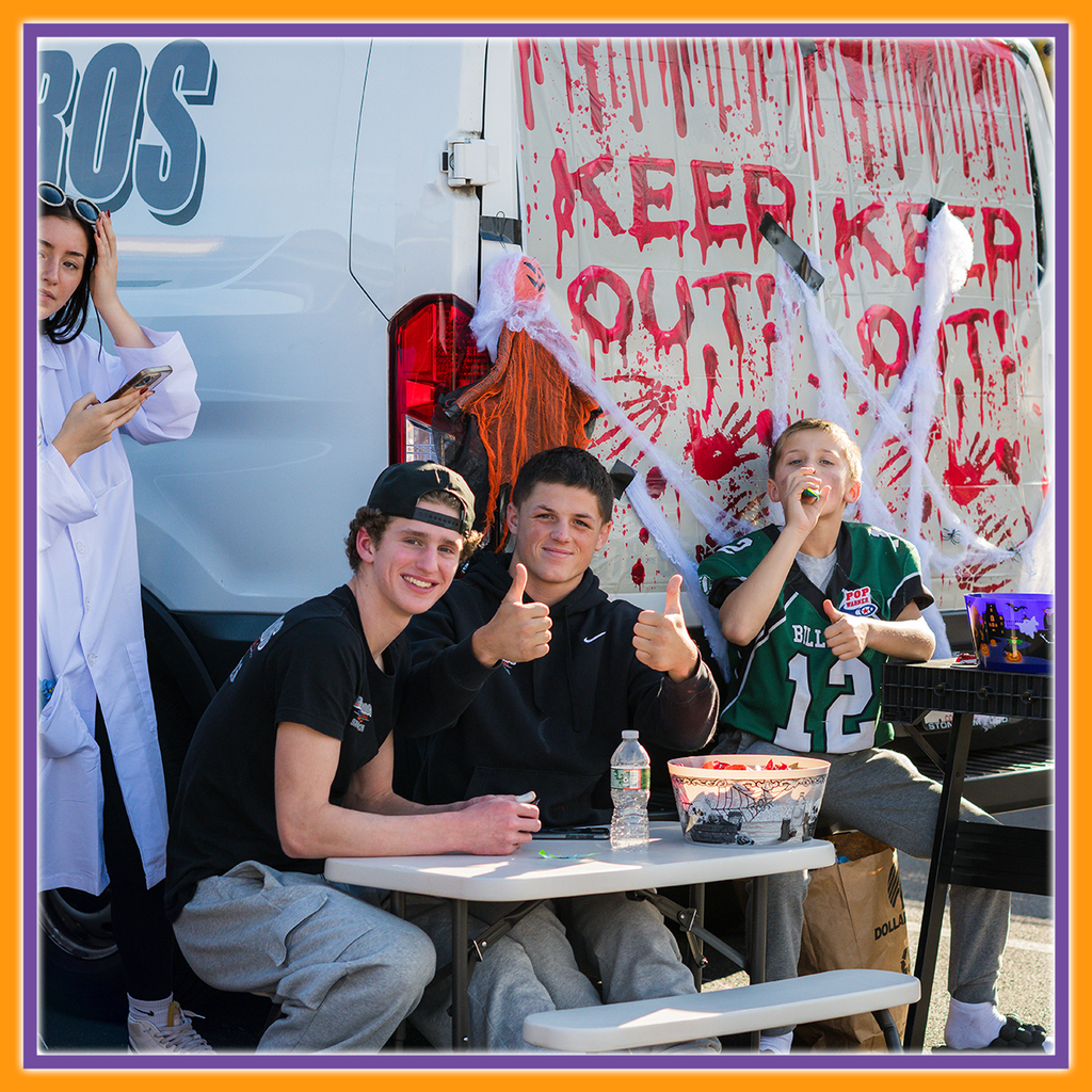 Students Smiling at the camera and giving a thumbs up 