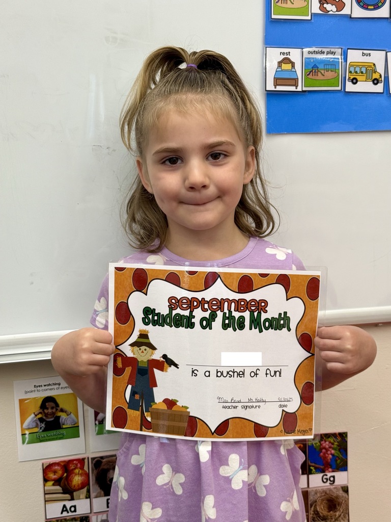 little girl holding certificate