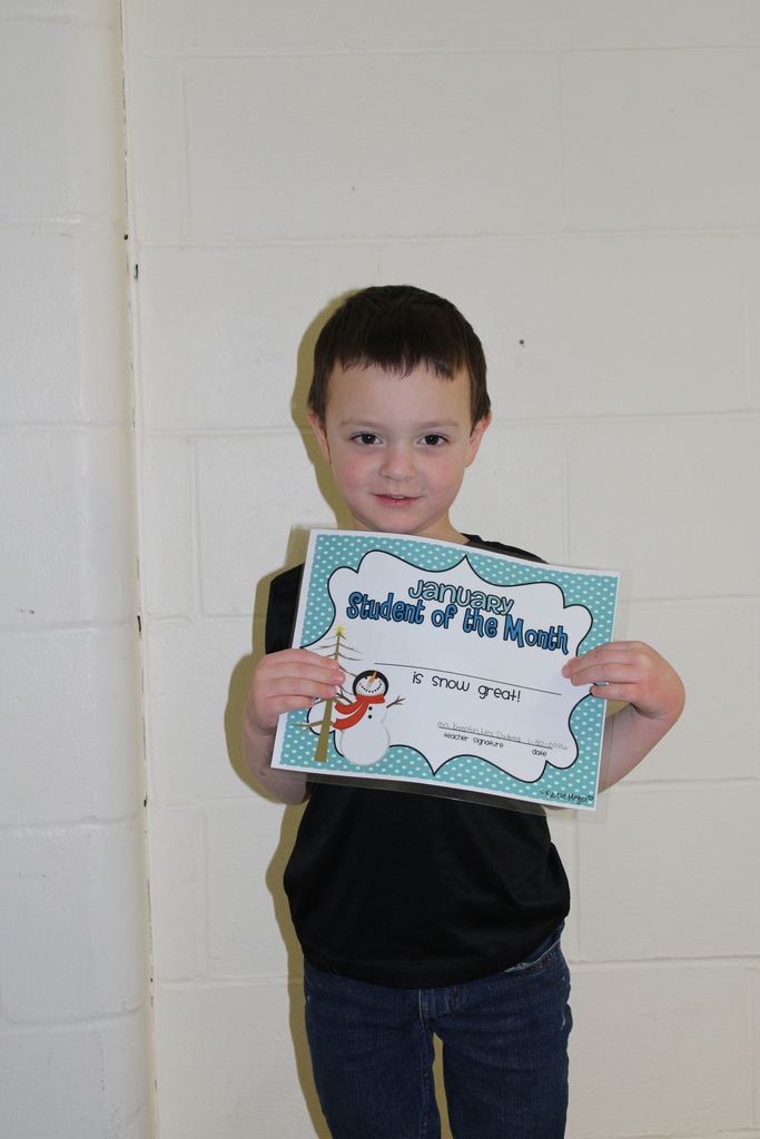 little boy holding certificate