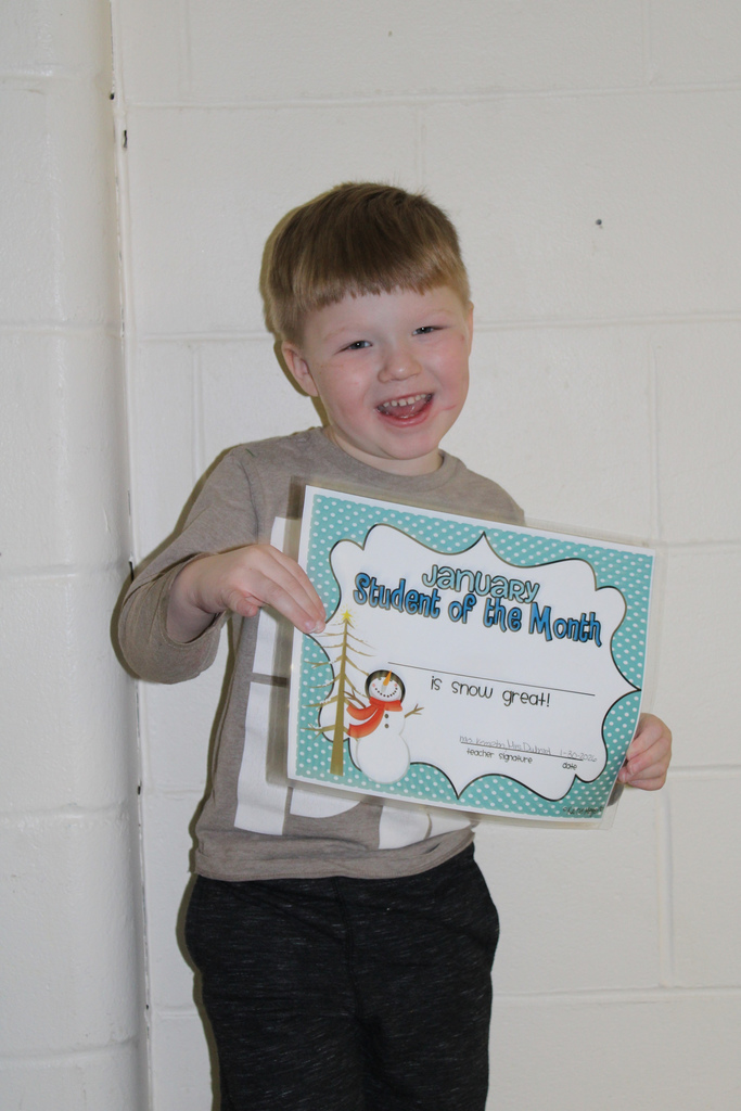 little boy holding certificate