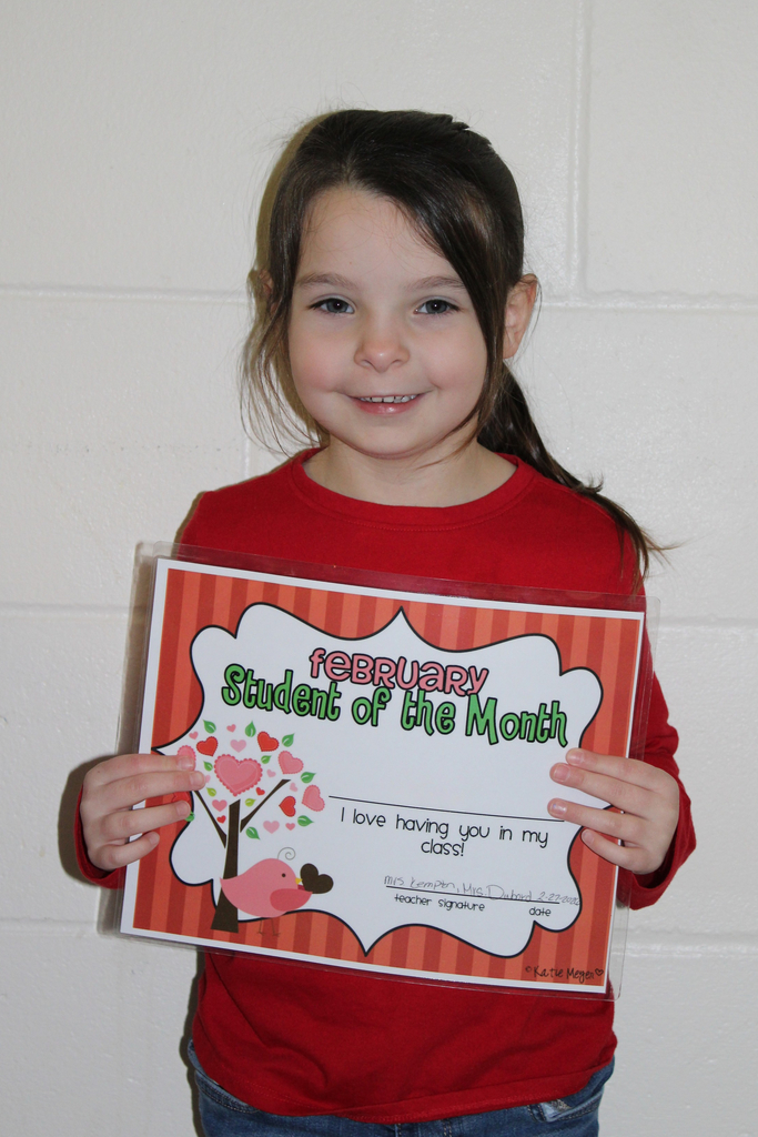 student holding certificate