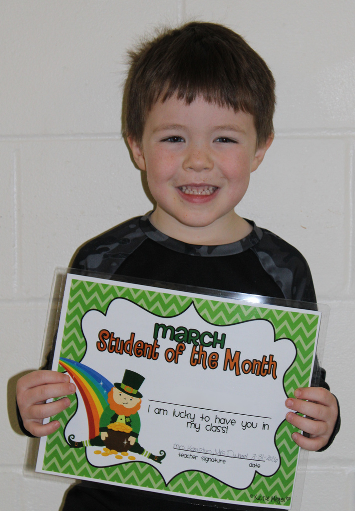 little boy holding certificate