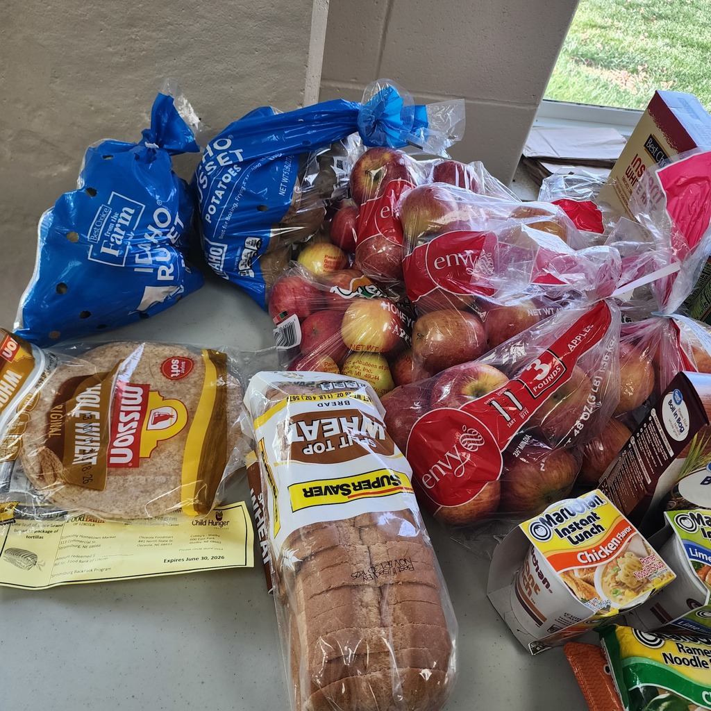 Picture of bags of potatoes, bags of apples, tortillas,  and wheat bread