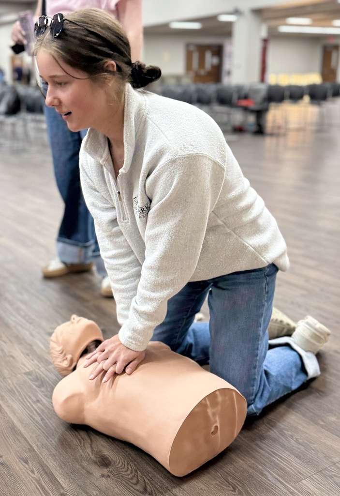 A student practices their CPR compressions.