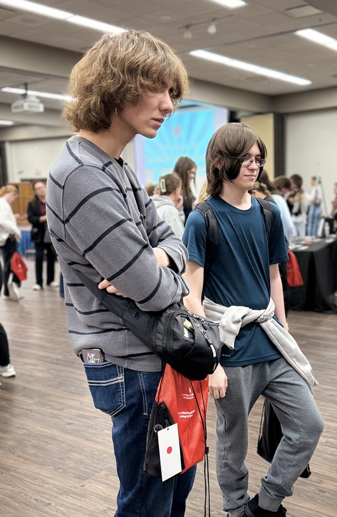 Two students listen to a presentation by a UNMC department representative.