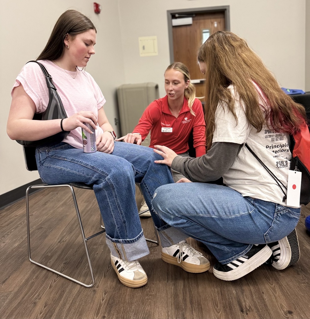 Two students learn about range-of-motion at the PT Booth.