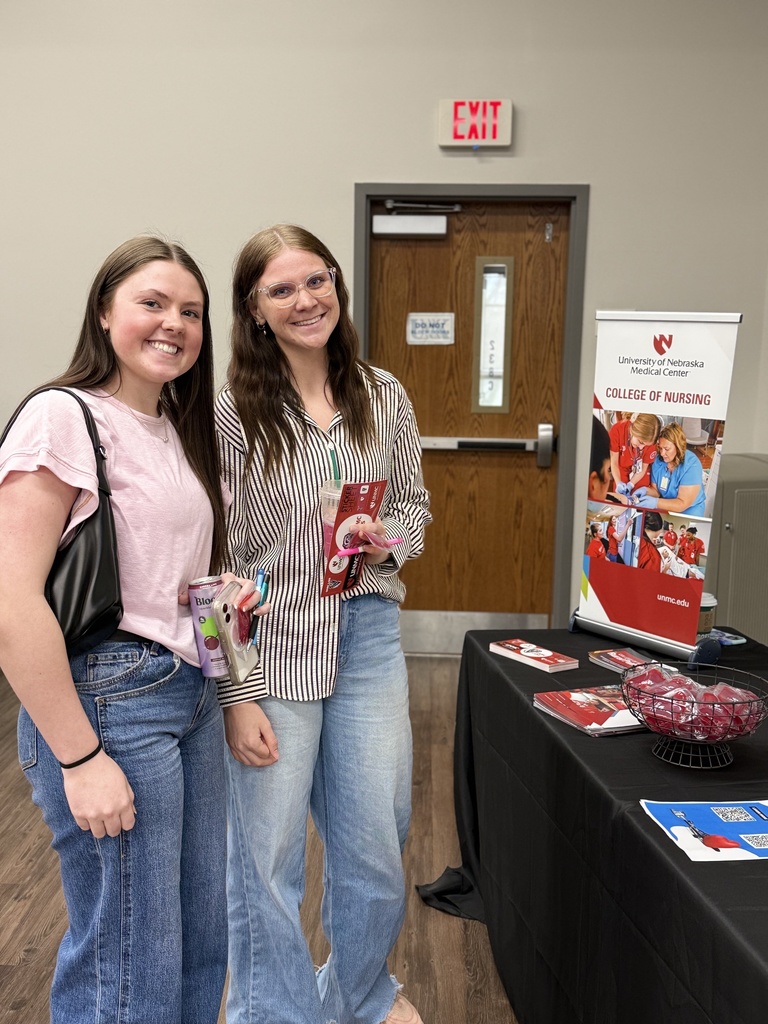 Two students learn about nursing at a UNMC Backstage Pass Booth.