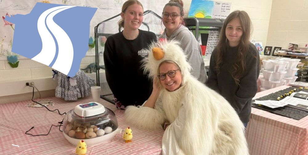 Cultivate students pose with Mrs. Burgin who is wearing a chicken suit outfit