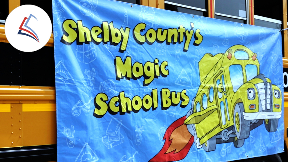 An SCPS school bus with the "Magic School Bus" sign hanging from its windows