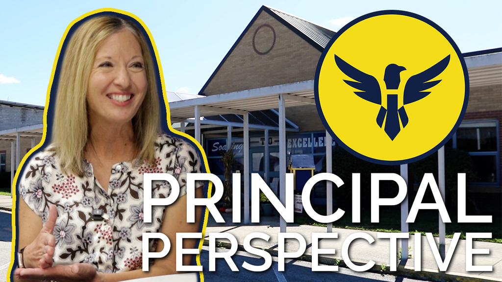 a video thumbnail image of Mrs Smith smiling, Photoshopped in front of the Heritage front door.