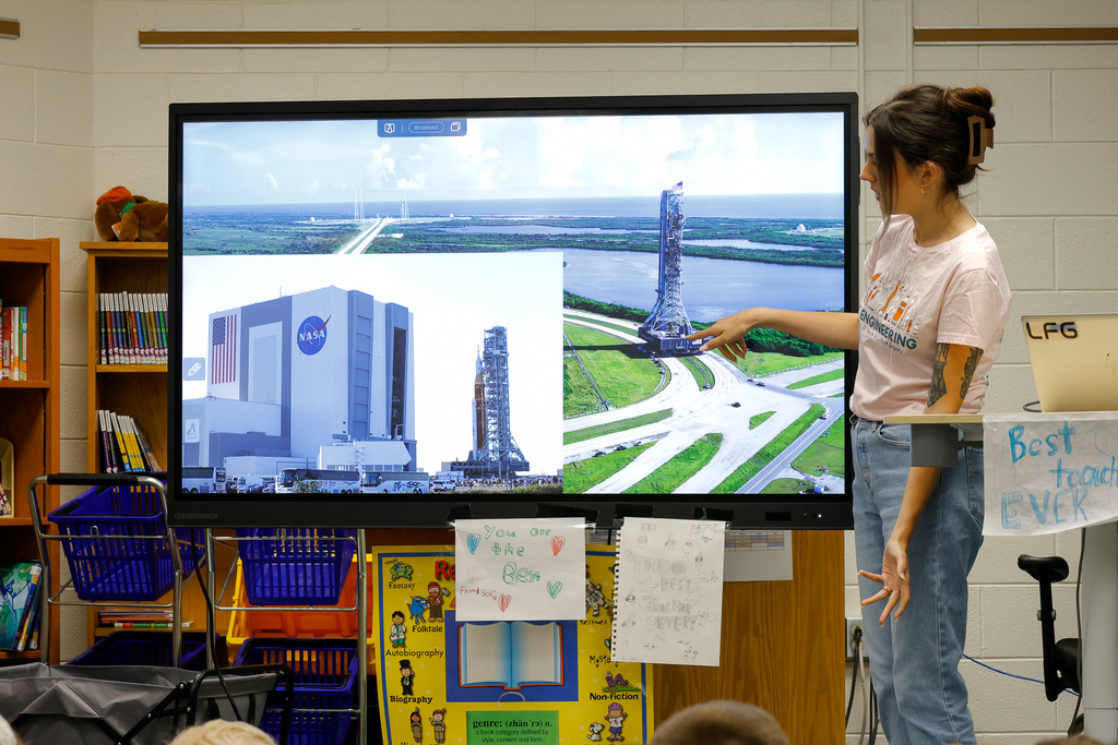 Alora explaining photos of the Artemis II Rocket being constructed