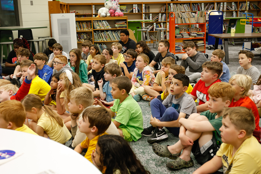 the group of students watching the presentation