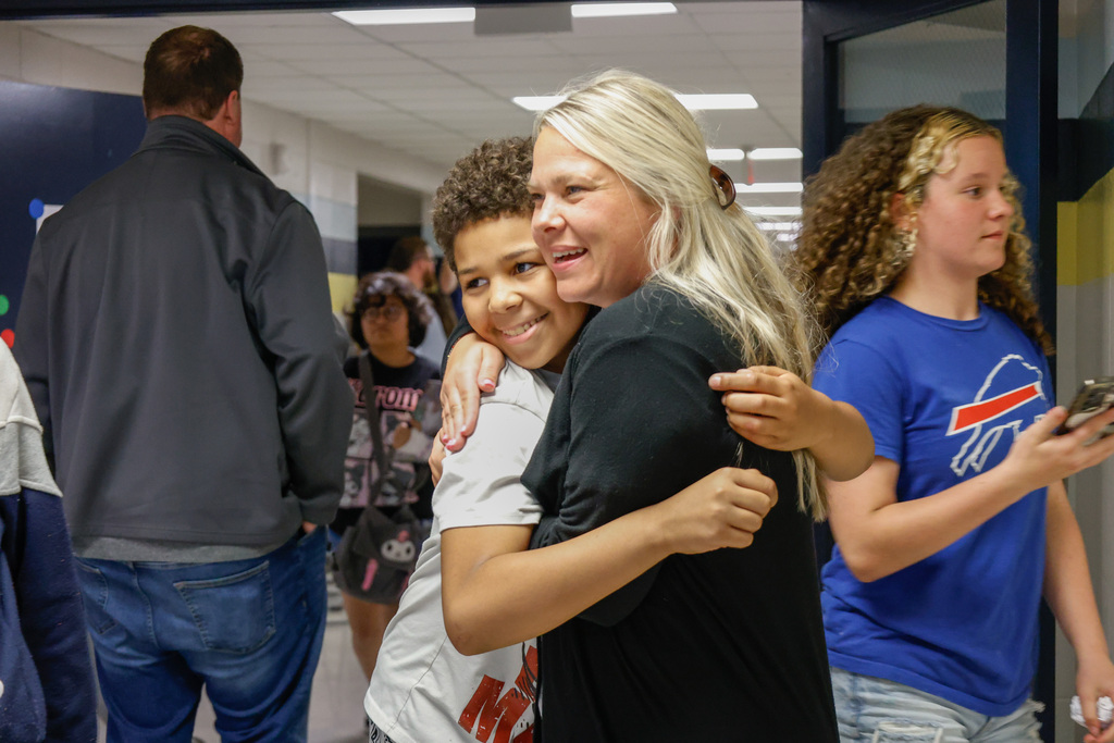 kids and teachers hugging goodbye