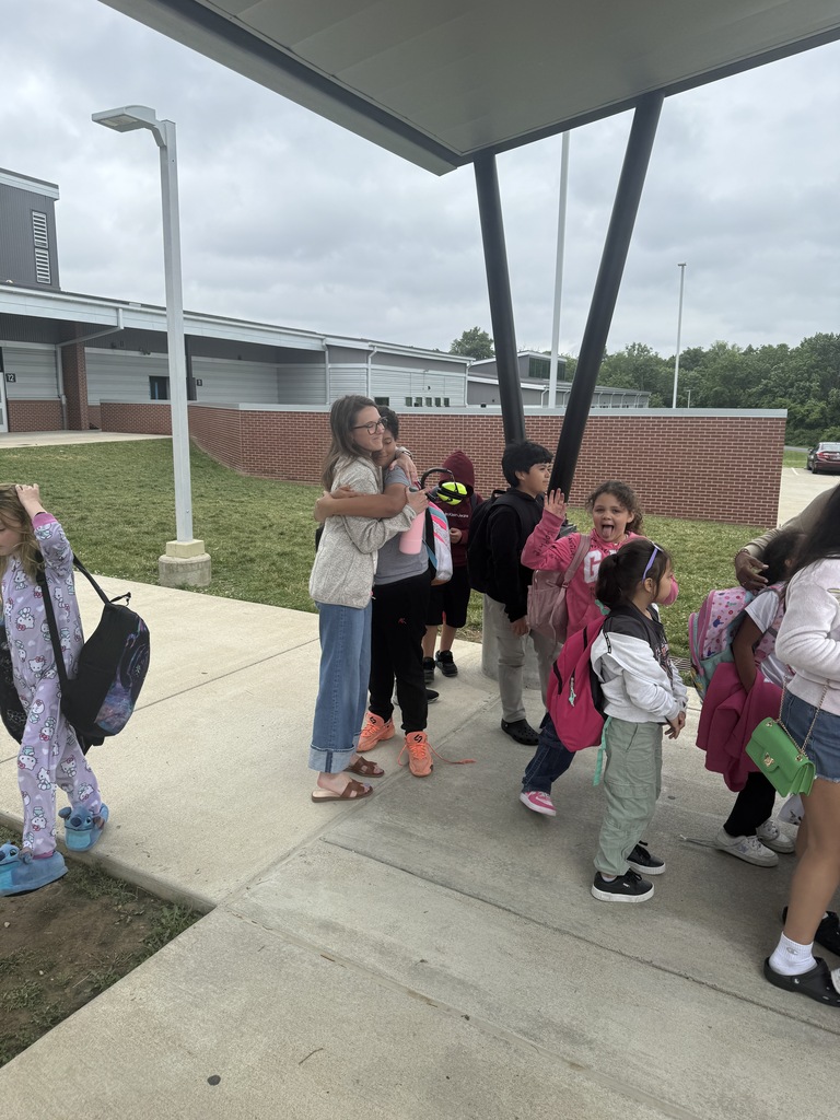 kids and teachers hugging goodbye