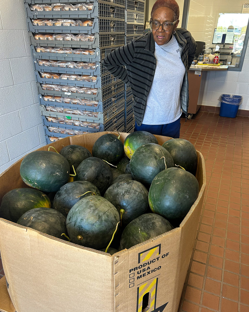 cafeteria staff preparing the watermelon