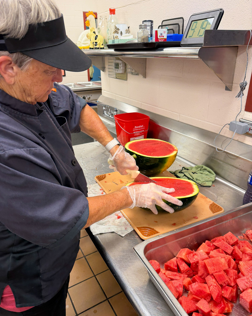 cafeteria staff preparing the watermelon