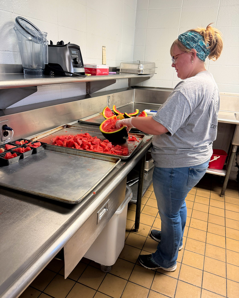 cafeteria staff preparing the watermelon