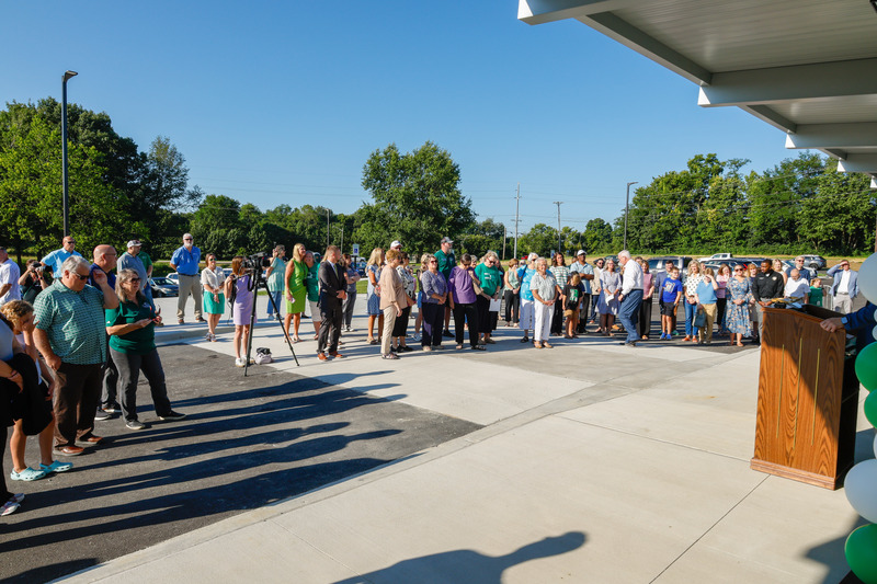 the crowd gather out front watching the ribbon cutting ceremony