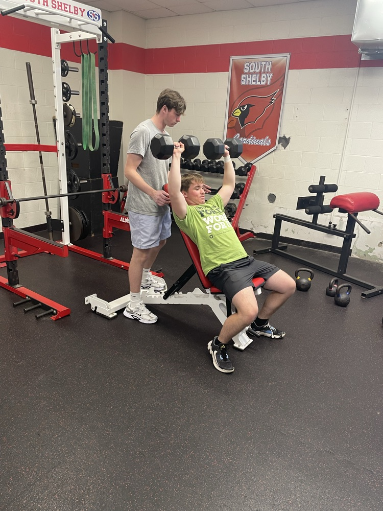 Ethan doing dumbbell incline bench with Jayden spotting for safety