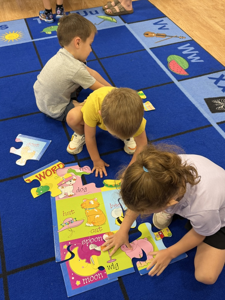 Students in Mrs. Larrick's class work together to complete a puzzle