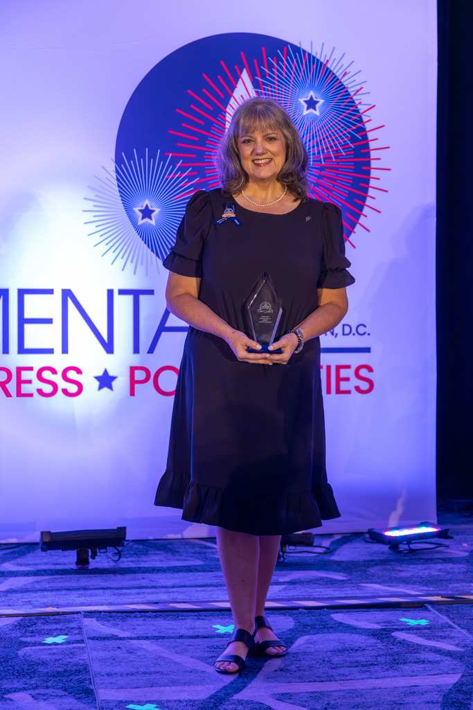 Cindy Warner holds her School Communicator of the Year award.