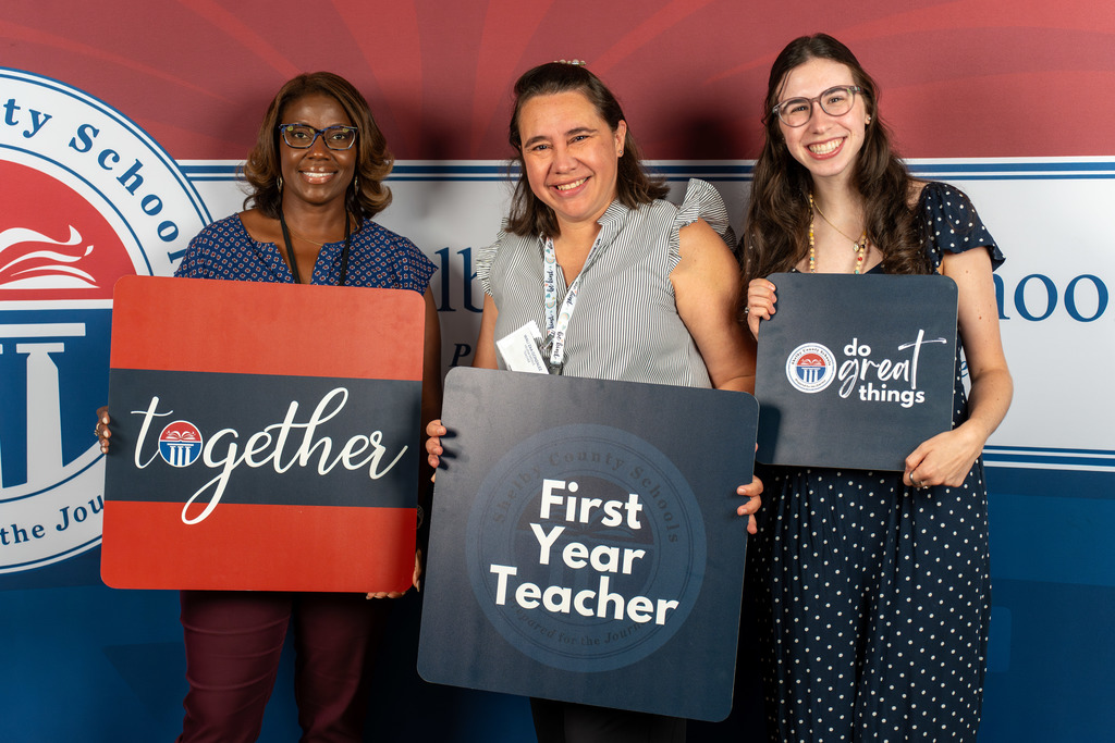 New team members smile for a photo.