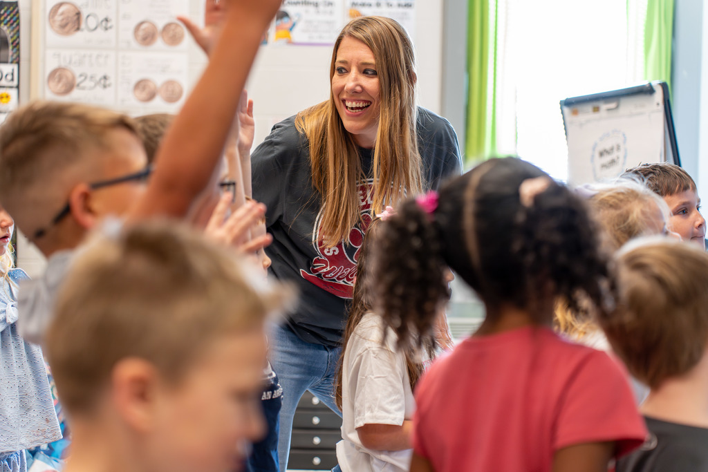 Teacher smiles at her class.