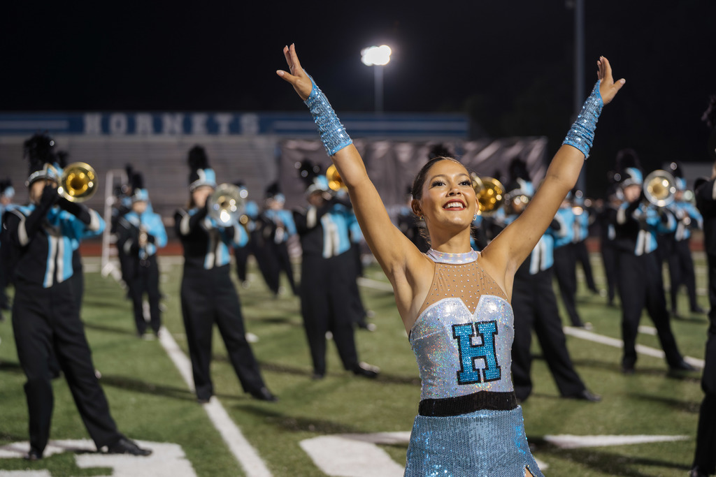 Helena dance team member in front of band.