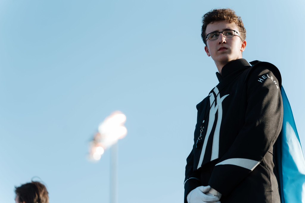Drum major stands on podium.