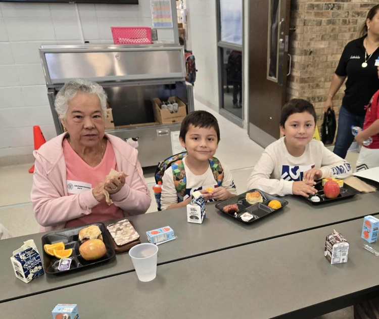 boys eating breakfast with grandmother 