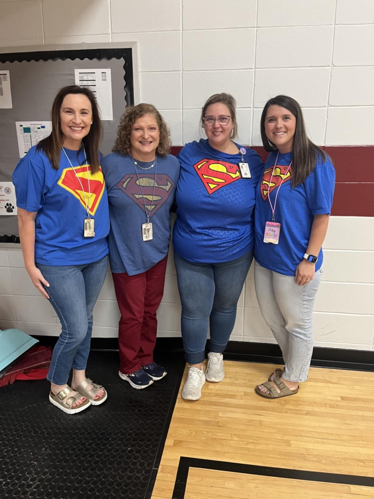 teachers in matching Superman shirts 